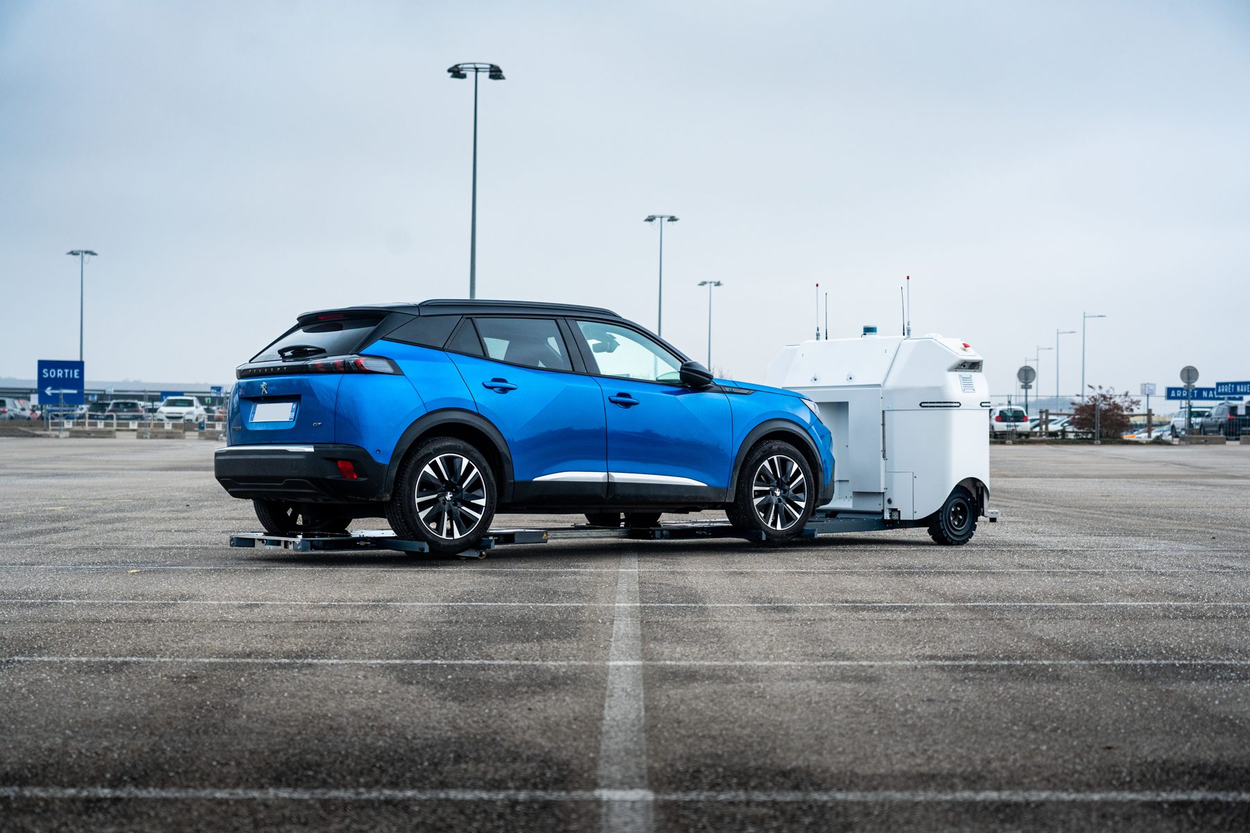 Stanley Robotics robot sliding a car across an airport parking lot